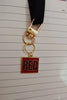 Third image of a taylor swift RED era themed keychain for swifties.