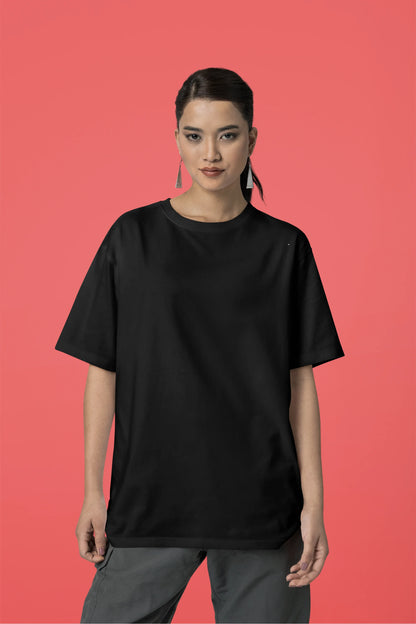 Front view of a female model wearing an oversized black t-shirt featuring a detailed illustration of a gray wolf howling at a full moon in a nighttime setting.