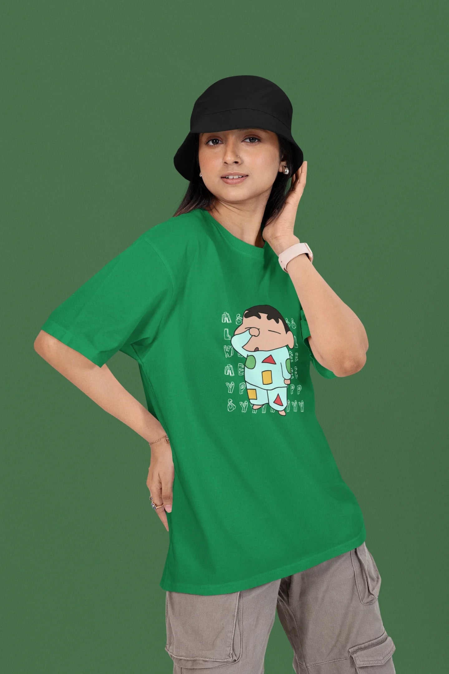 First front view of a female model wearing a forest green oversized t-shirt featuring  Shinchan looking sleepy.