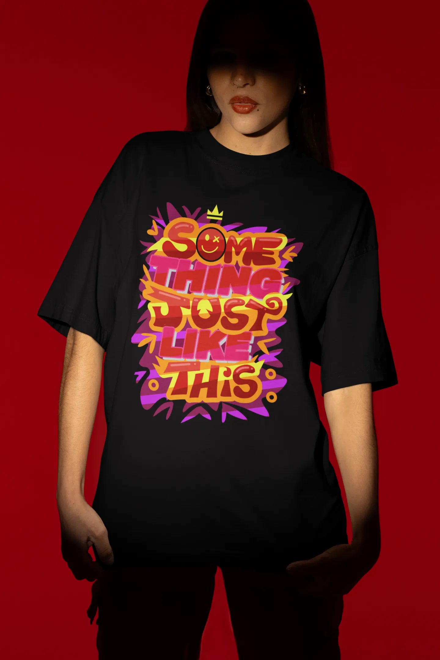 Third front view of a female model wearing an black oversized t-shirt featuring the designs inspired from Coldplay's "Something Just Like This" music video.