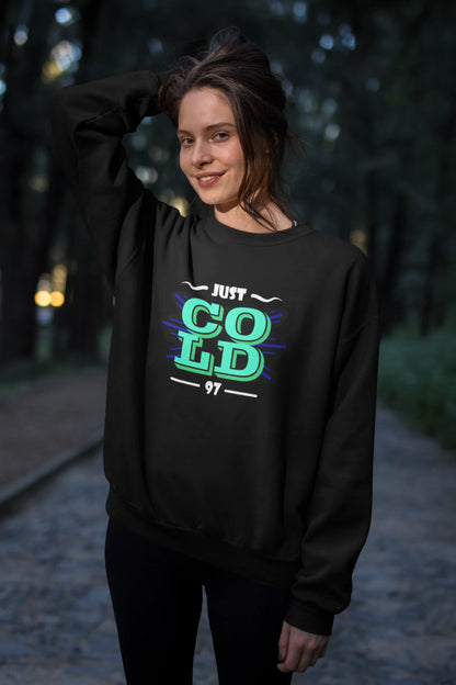 Second front view of a female model wearing an black sweatshirt with the text "Just Cold" printed on it.