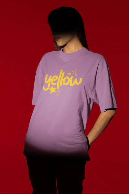 Second front view of a female model wearing a dirty purple oversized t-shirt with the "Yellow" album artwork by Coldplay.