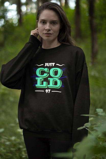 Third front view of a female model wearing an black sweatshirt with the text "Just Cold" printed on it.