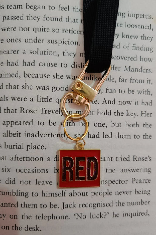 Second image of a taylor swift RED era themed keychain for swifties.
