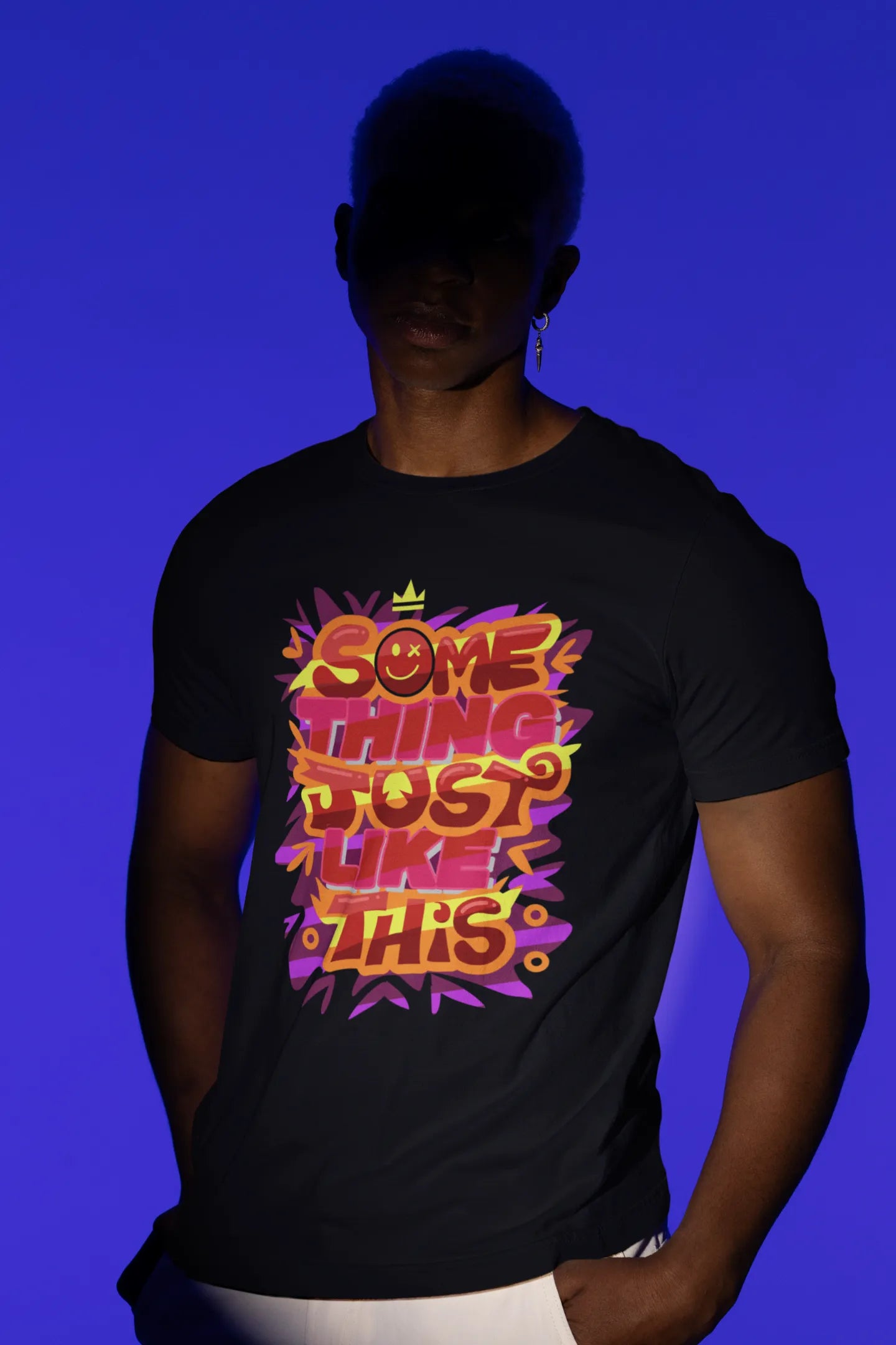 First front view of a male model wearing an black oversized t-shirt featuring the designs inspired from Coldplay's "Something Just Like This" music video.