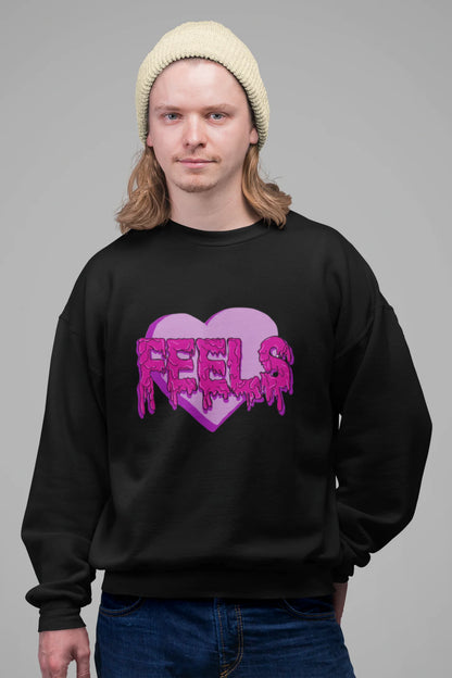 4th front view of a male model wearing a black sweatshirt featuring a heart with melting "Feels" text.