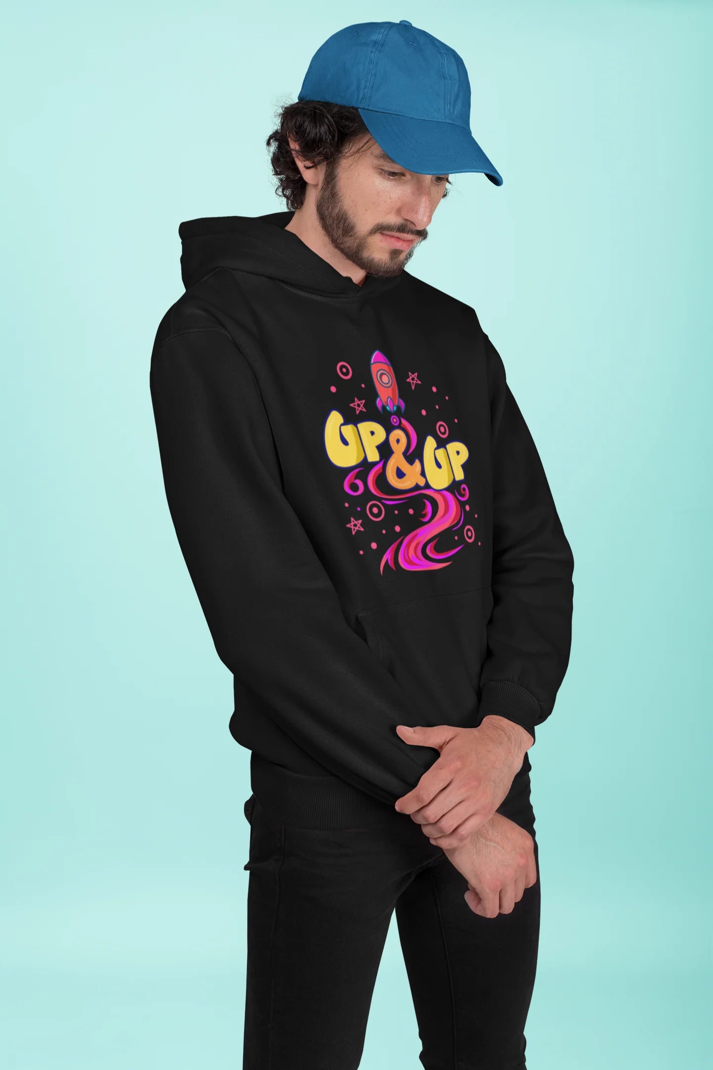 Third front view of a male model wearing an black hoodie with a rocket ship design and the text "Up & Up".