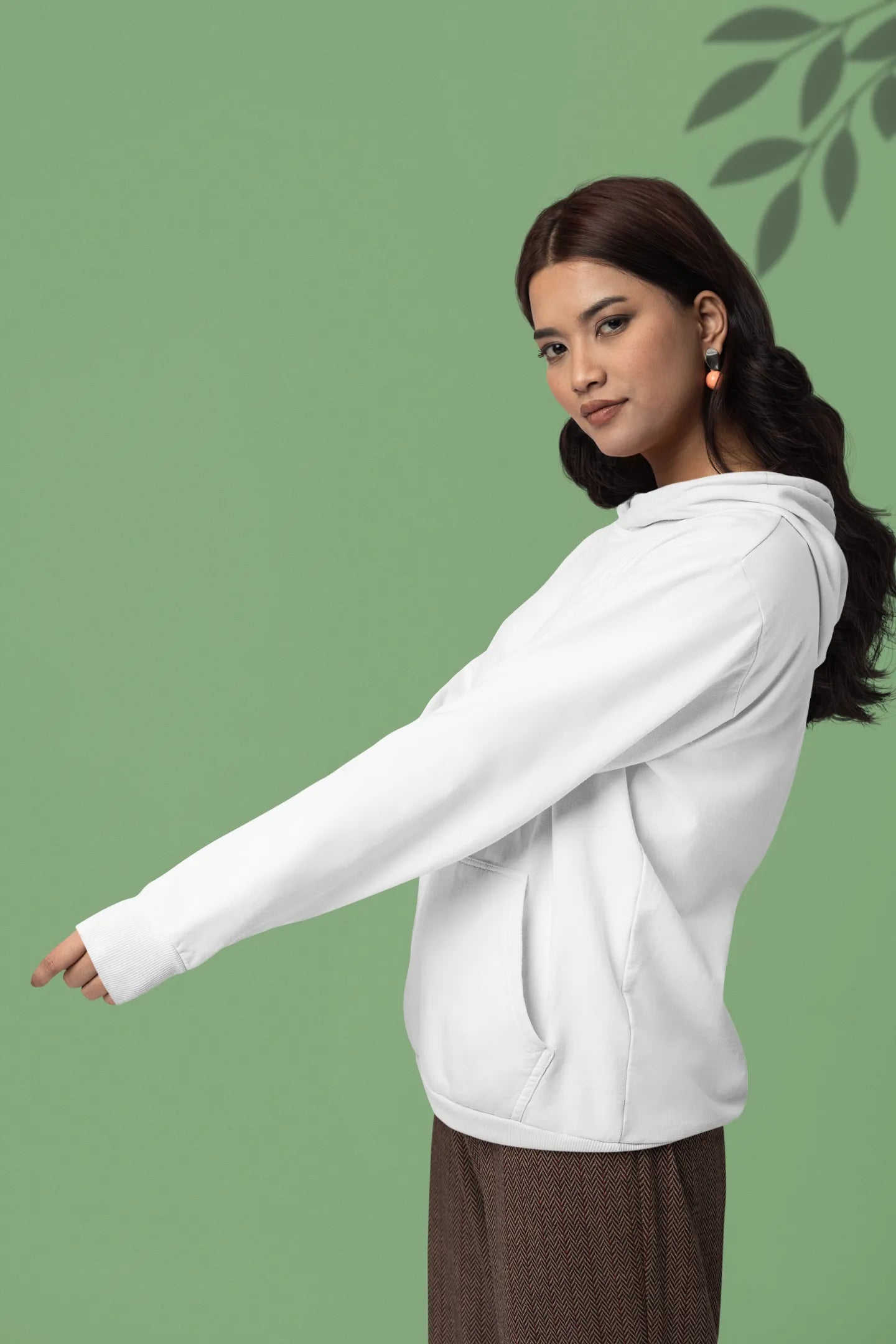 Third front view of a female model wearing a white hoodie with a panda fox surrounded by bamboo.
