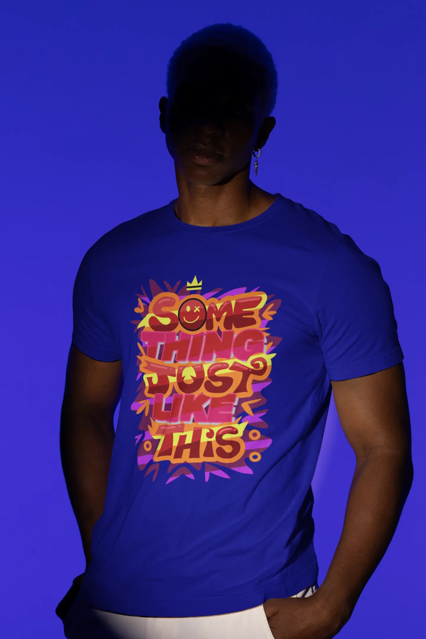 First front view of a male model wearing an royal blue oversized t-shirt featuring the designs inspired from Coldplay's "Something Just Like This" music video.