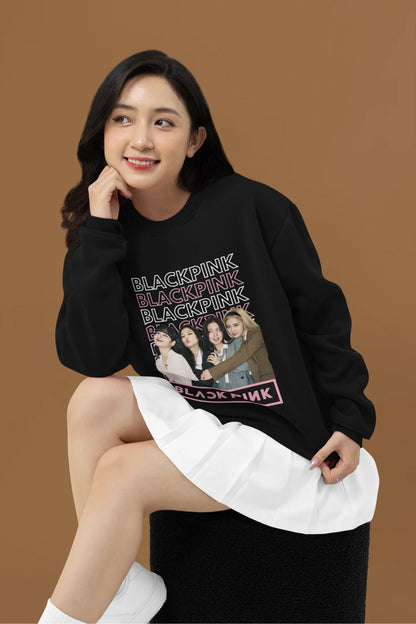Fourth front view of a female model wearing a black sweatshirt featuring a stylish design inspired by the K-Pop girl group Blackpink. Ideal for Blinks (Blackpink fans) and K-Pop music enthusiasts.