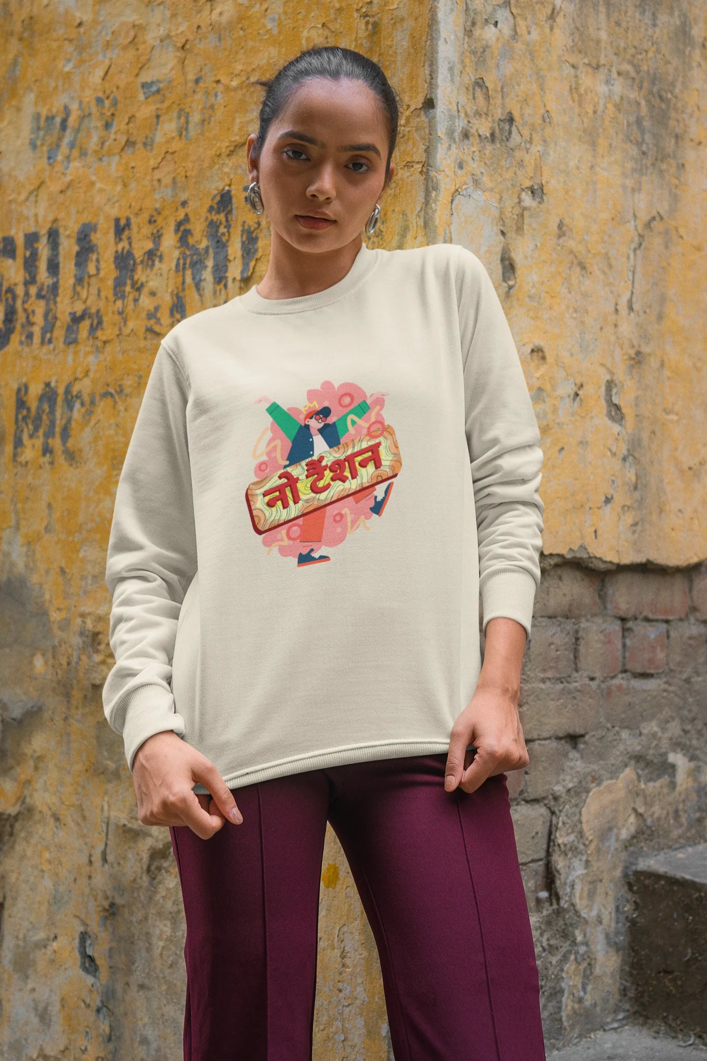 4th front view of a female model wearing a cream oversized t-shirt with the phrase "No Tension" in a relaxed, unique script.
