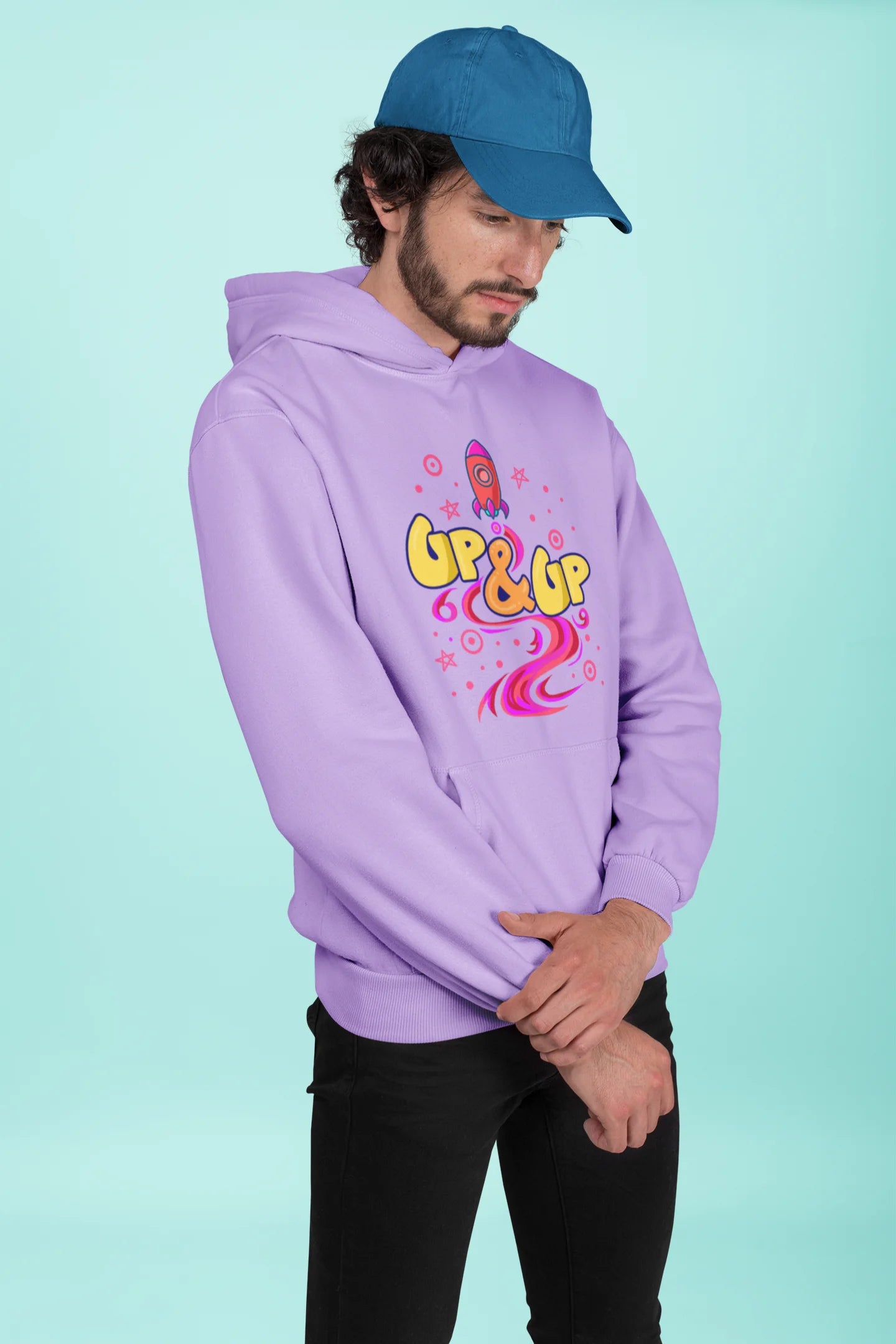 Third front view of a male model wearing an lavender hoodie with a rocket ship design and the text "Up & Up".