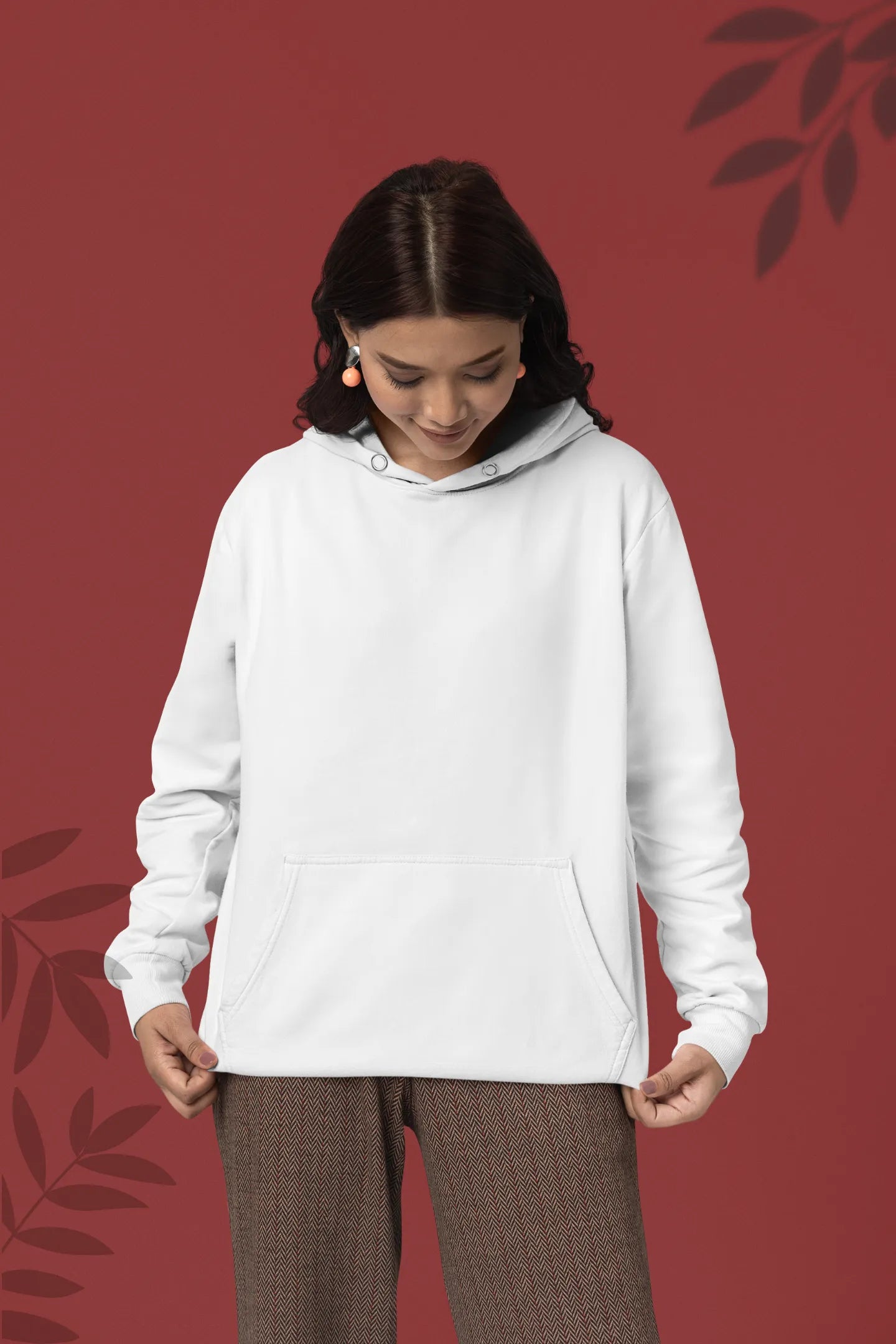 Second front view of a female model wearing a white hoodie with a panda fox surrounded by bamboo.