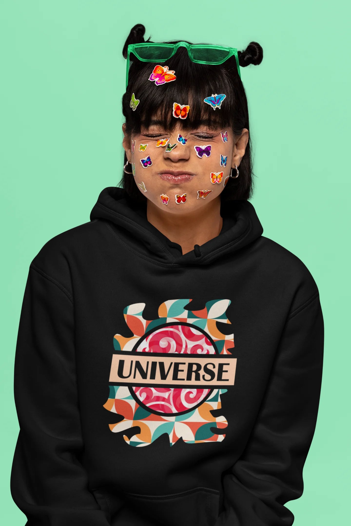 6th front view of a female model wearing an black hoodie with a cosmic Universe design inspired by Coldplay.