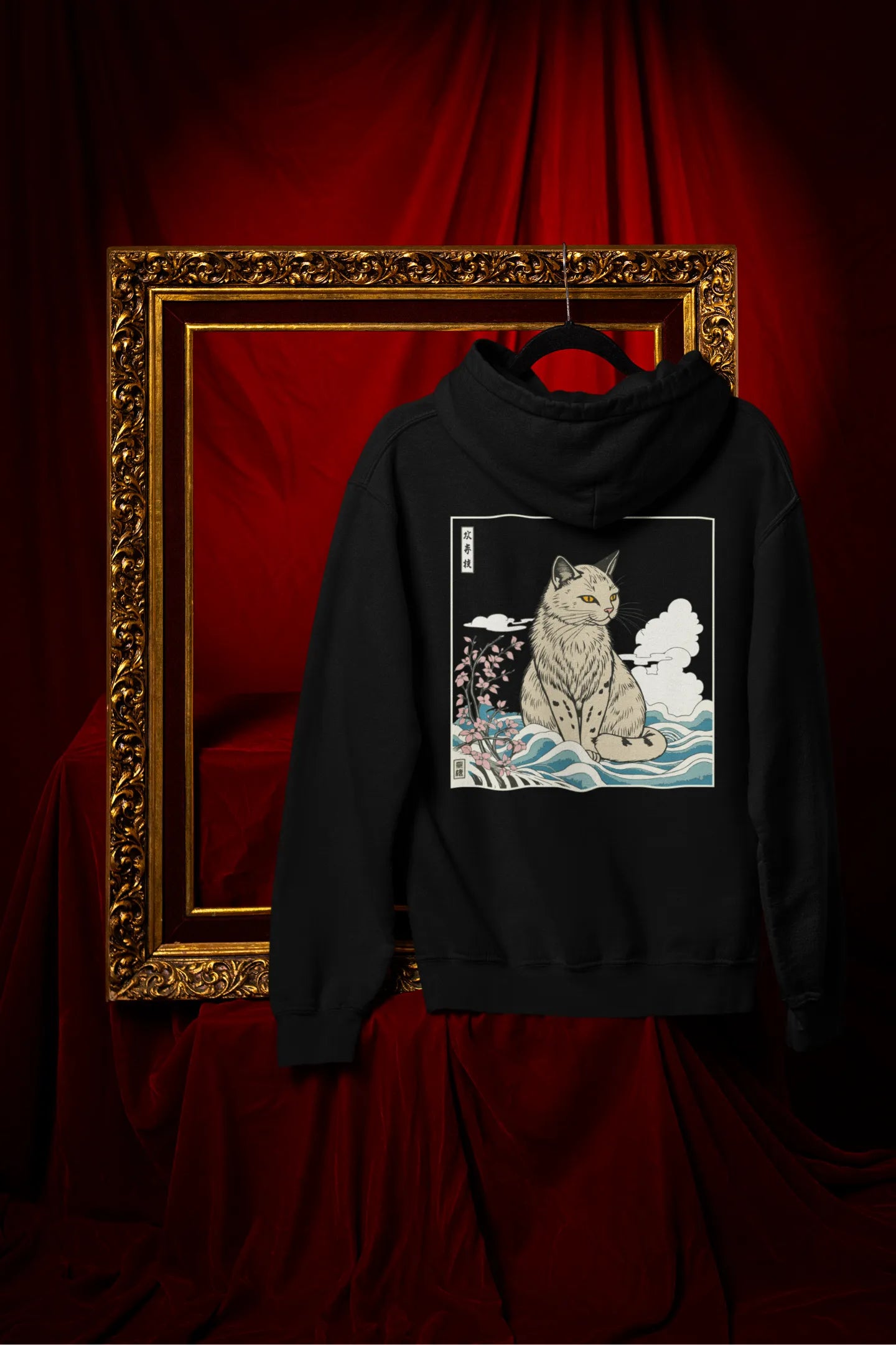 Back view of a black hoodie with a design of a wildcat sitting on ocean waves.