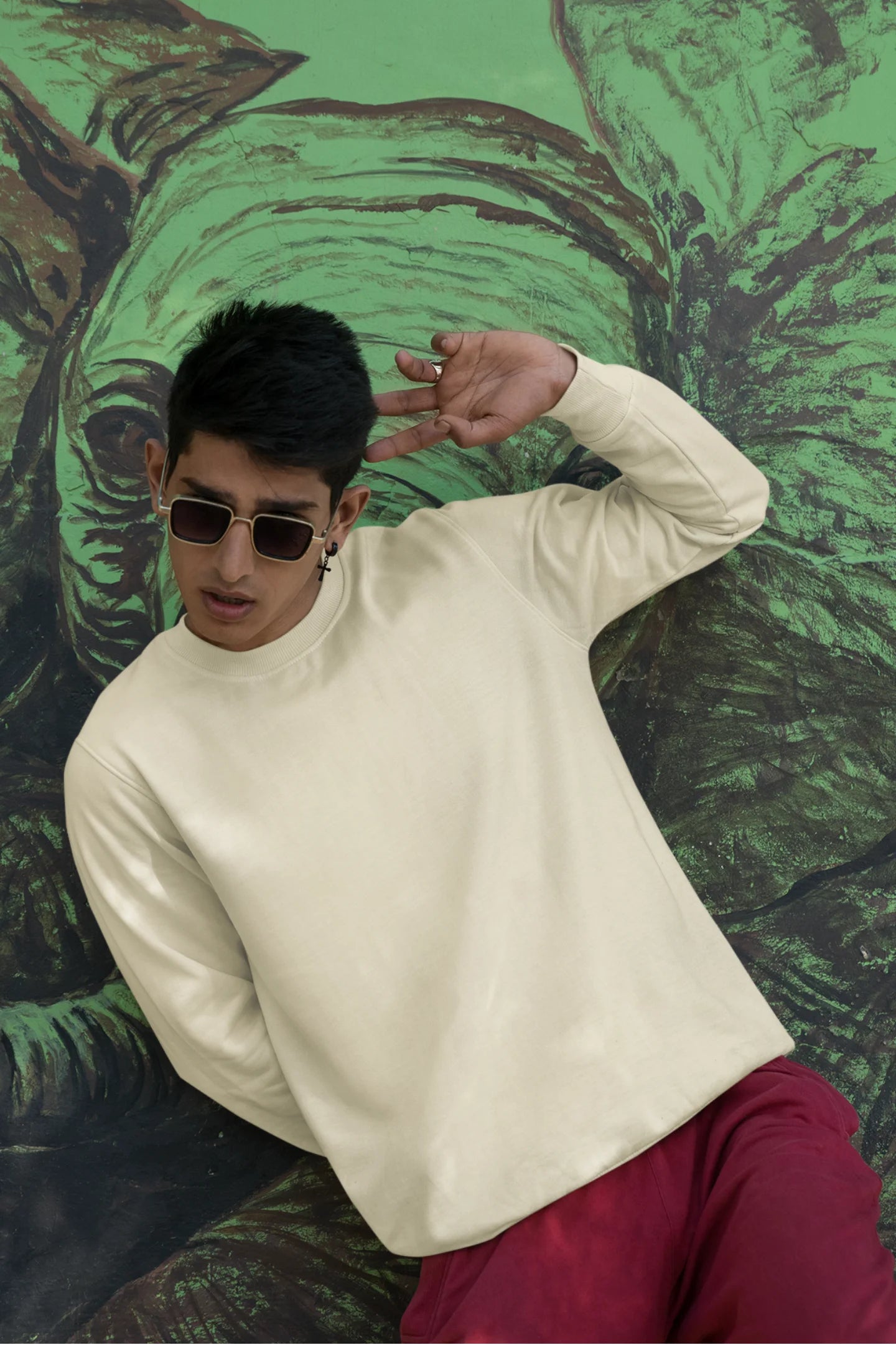 First front view of a male model wearing a off-cream F.R.I.E.N.D.S. sweatshirt featuring a fun design inspired by Phoebe Buffay and her iconic quotes.