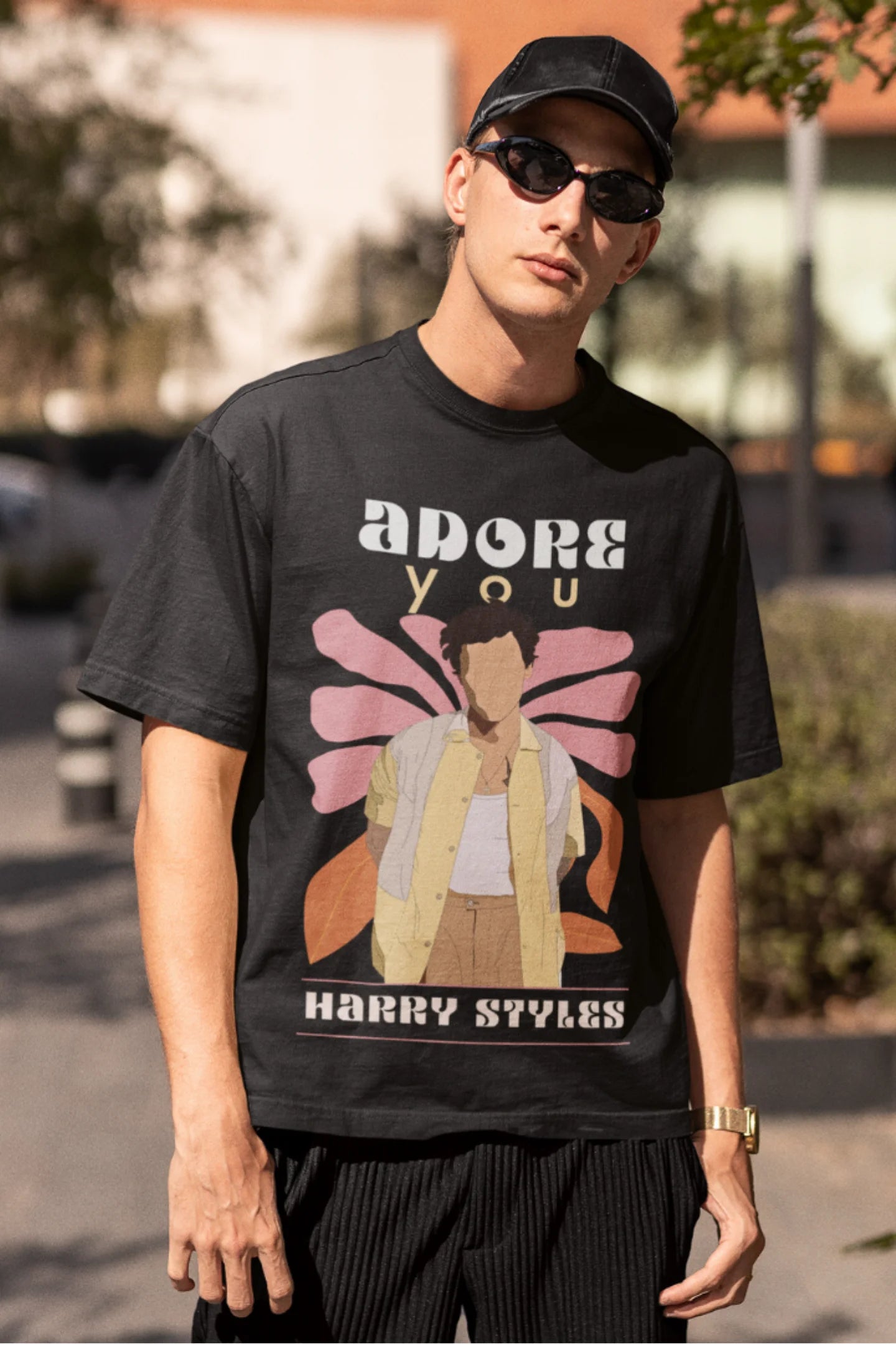 Third image of man wearing black oversized t-shirt featuring 'Adore You' inspired design - ideal for fans of Harry Styles and One Direction