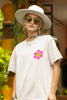 Close up view of a female model wearing an oversized off-white t-shirt with a positive message 