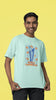 Second front image of male model wearing a mint green oversized t-shirt featuring the World Cup 2024 trophy with the text 