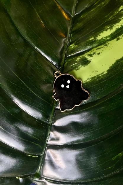 First view of a charm featuring a cute 
 black spooky adorable ghost design.