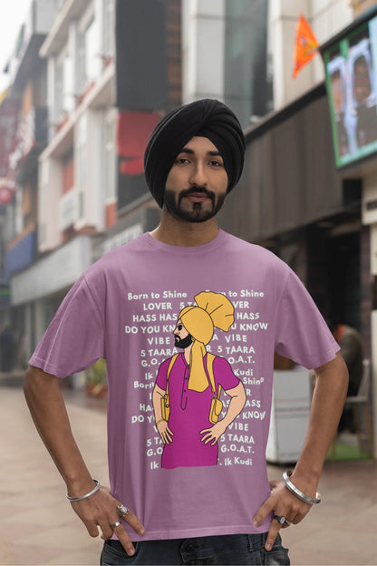 Third image of a male model wearing a dirty purple oversized t-shirt with a Diljit Dosanjh portrait on a t-shirt with his album titles written in the background.