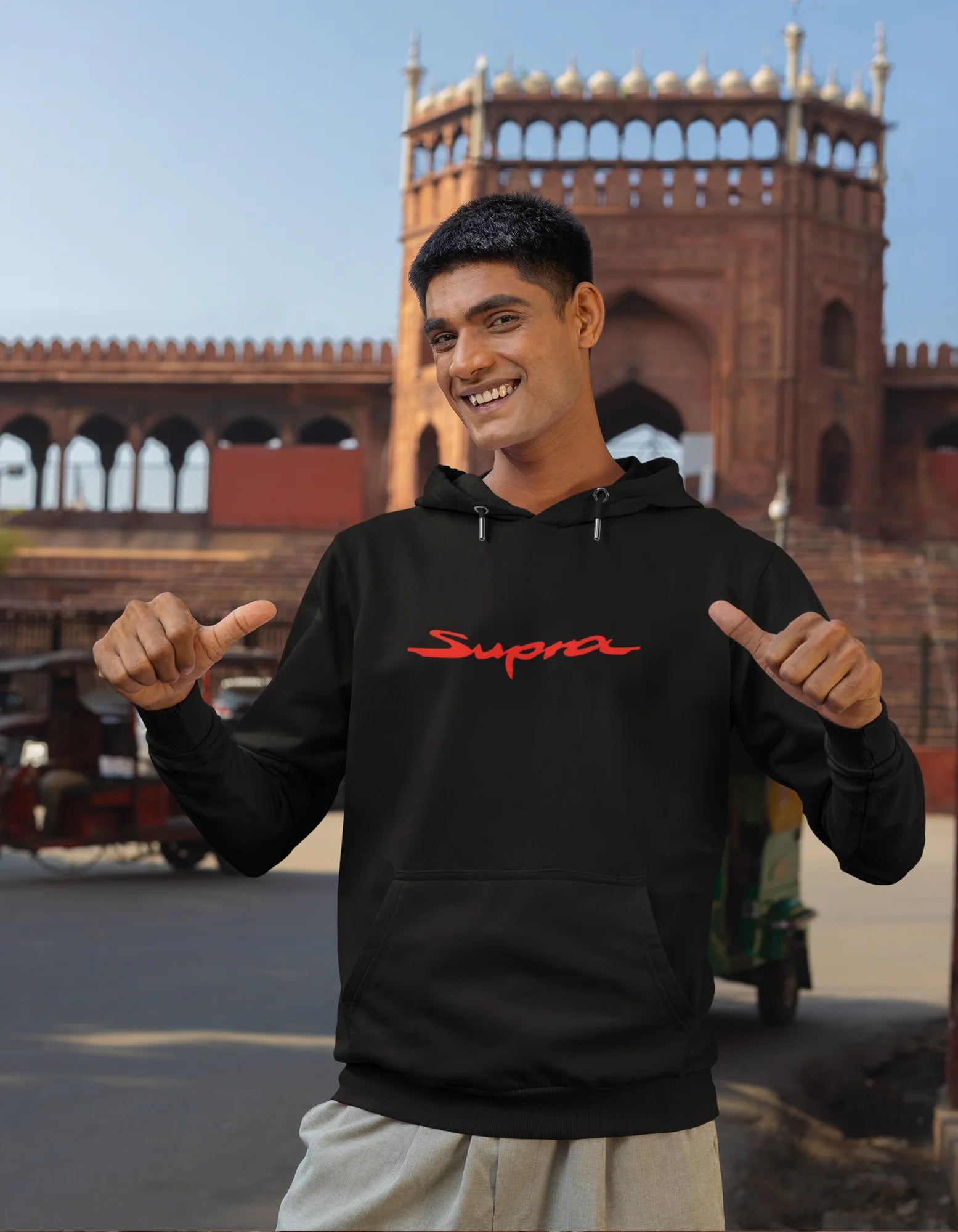 Second front view of a male model wearing a black hoodie featuring a Toyota Supra design, exuding speed and power.