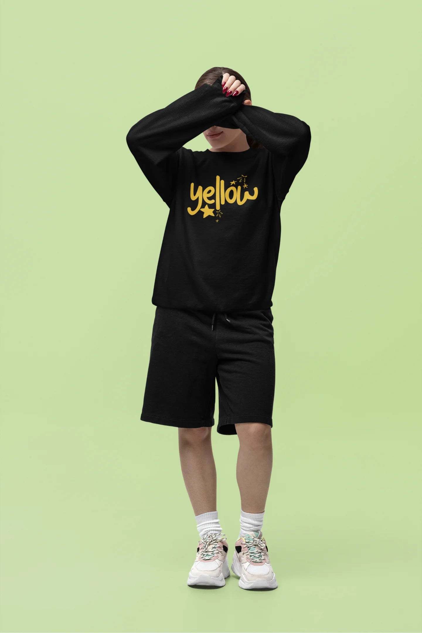 Fourth front view of a female model wearing a black sweatshirt with the "Yellow" album artwork by Coldplay.