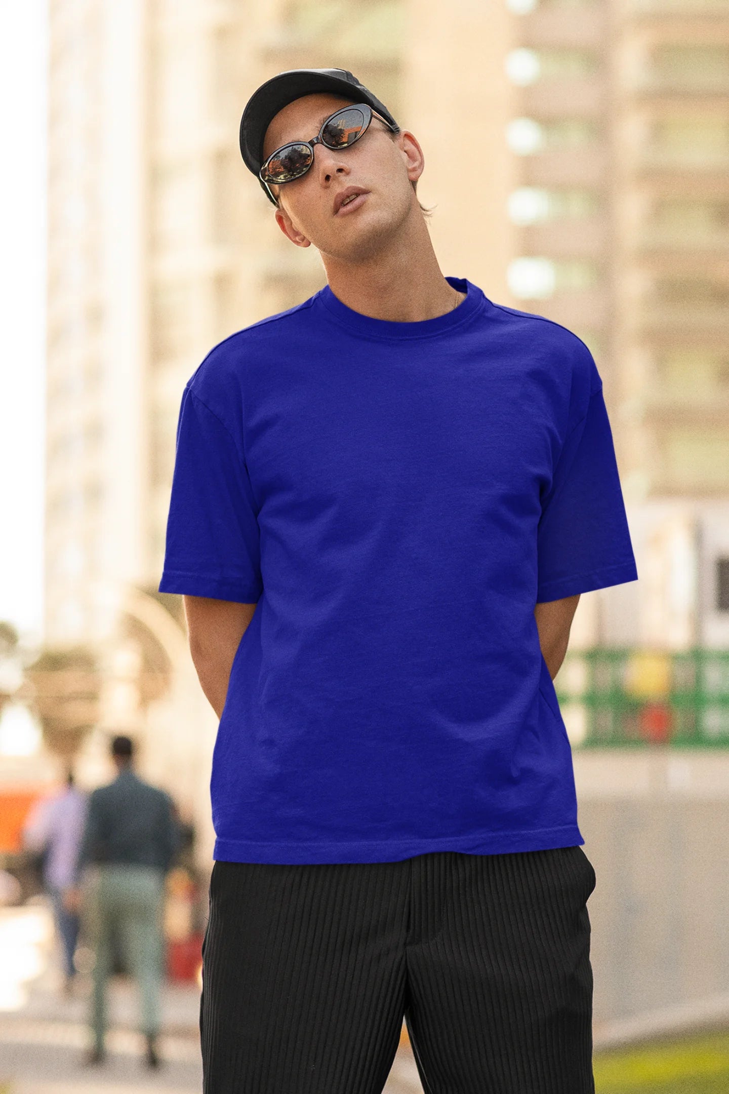 Front view of man wearing blue Oversize Taylor Swift T-Shirt featuring Fortnight Theme on its back.