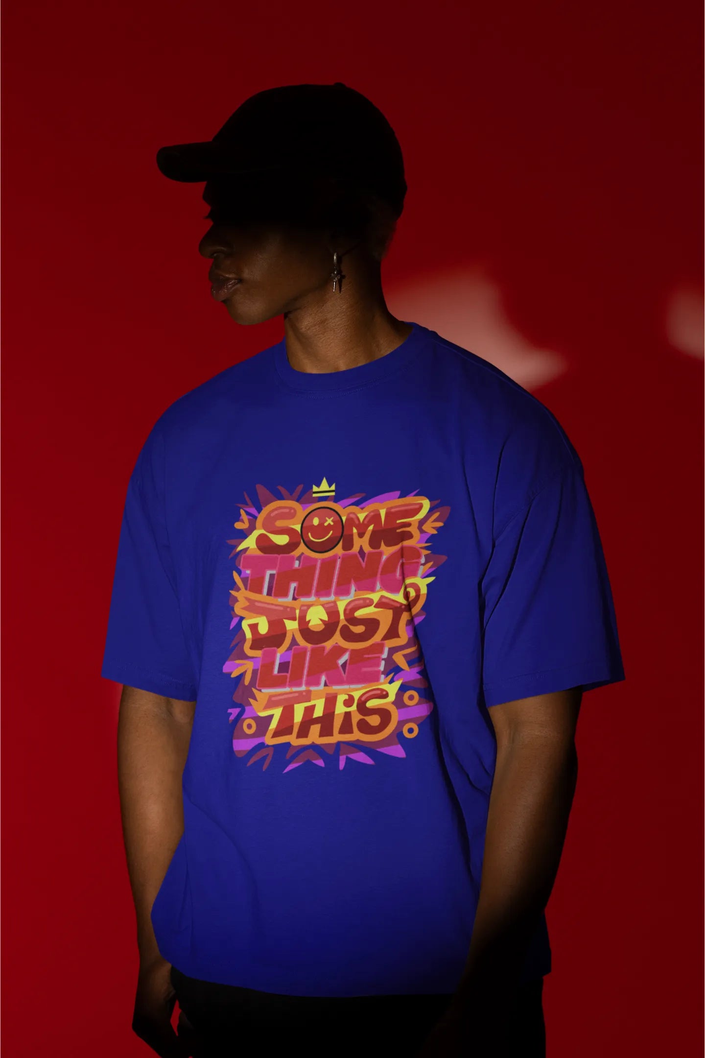 Second front view of a male model wearing an royal blue oversized t-shirt featuring the designs inspired from Coldplay's "Something Just Like This" music video.