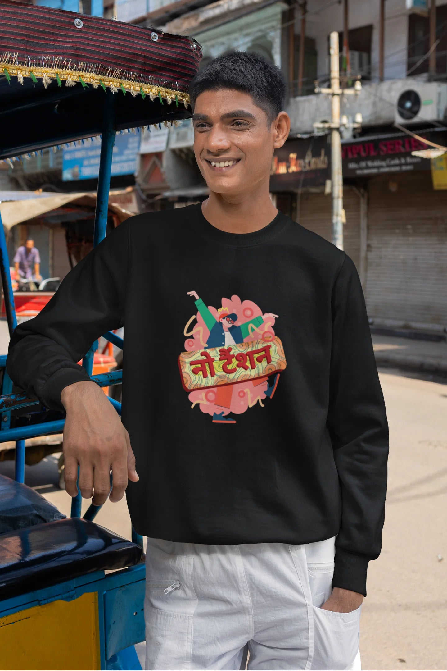 2nd front view of a male model wearing a black oversized t-shirt with the phrase "No Tension" in a relaxed, unique script.