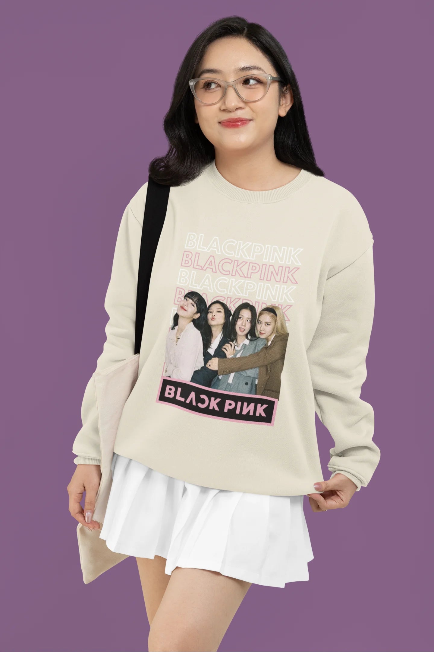 Third front view of a female model wearing a cream sweatshirt featuring a stylish design inspired by the K-Pop girl group Blackpink. Ideal for Blinks (Blackpink fans) and K-Pop music enthusiasts.