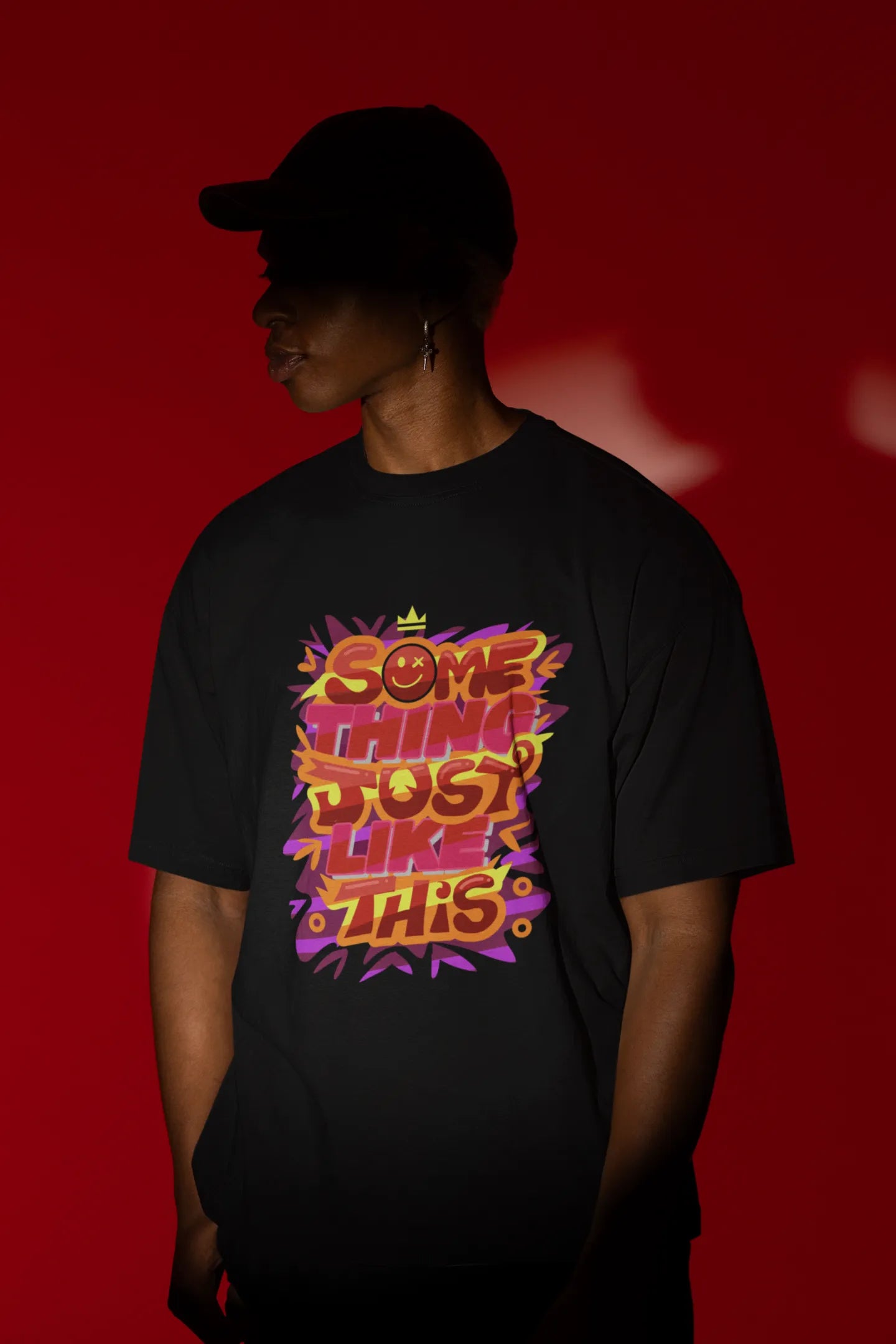 Second front view of a male model wearing an black oversized t-shirt featuring the designs inspired from Coldplay's "Something Just Like This" music video.