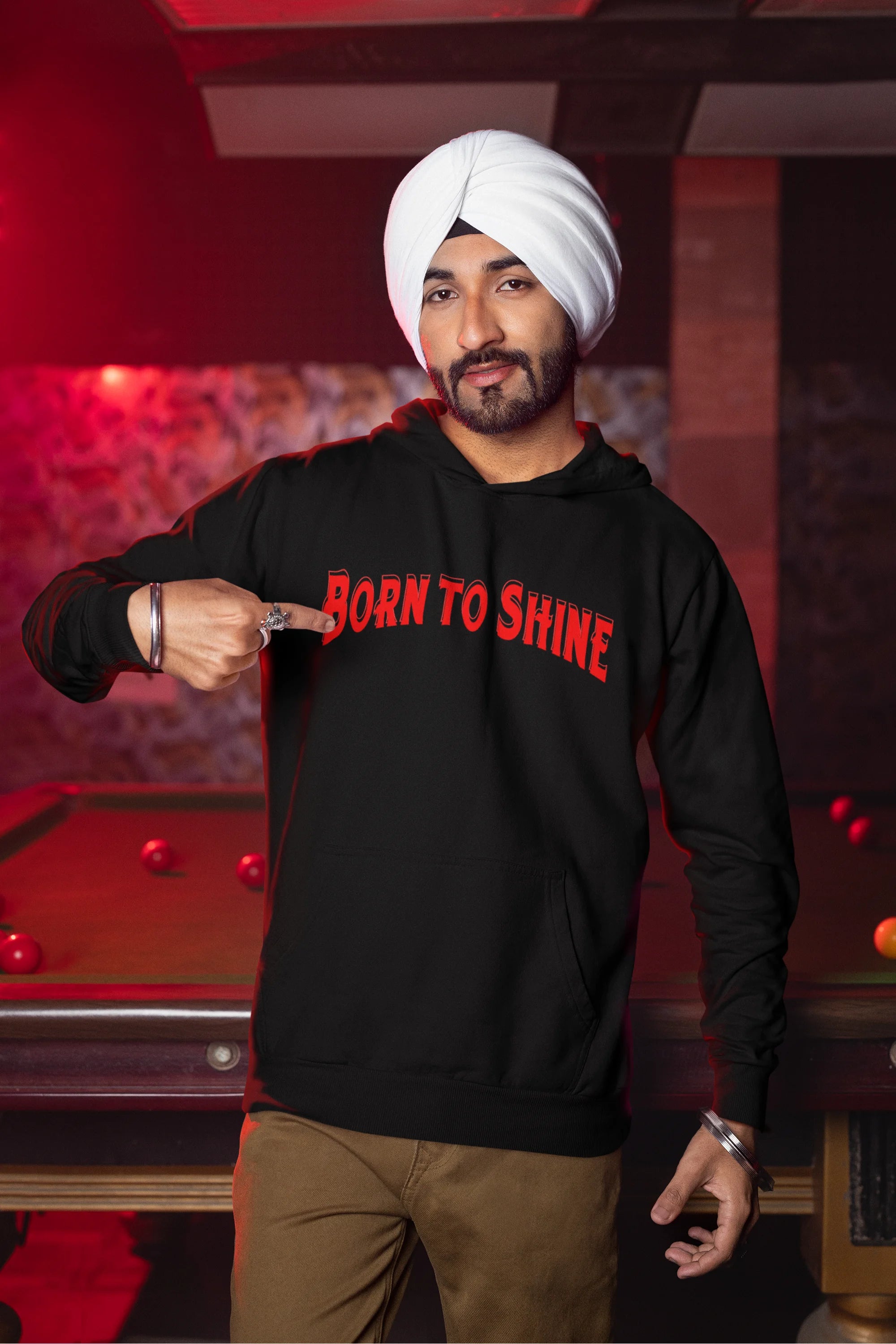 First front view of a male model wearing a black Diljit Dosanjh hoodie with the text "Born to Shine."