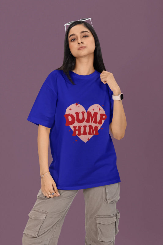 First front view of a female model wearing a royal blue oversized t-shirt with the text "Dump Him" printed on it.
