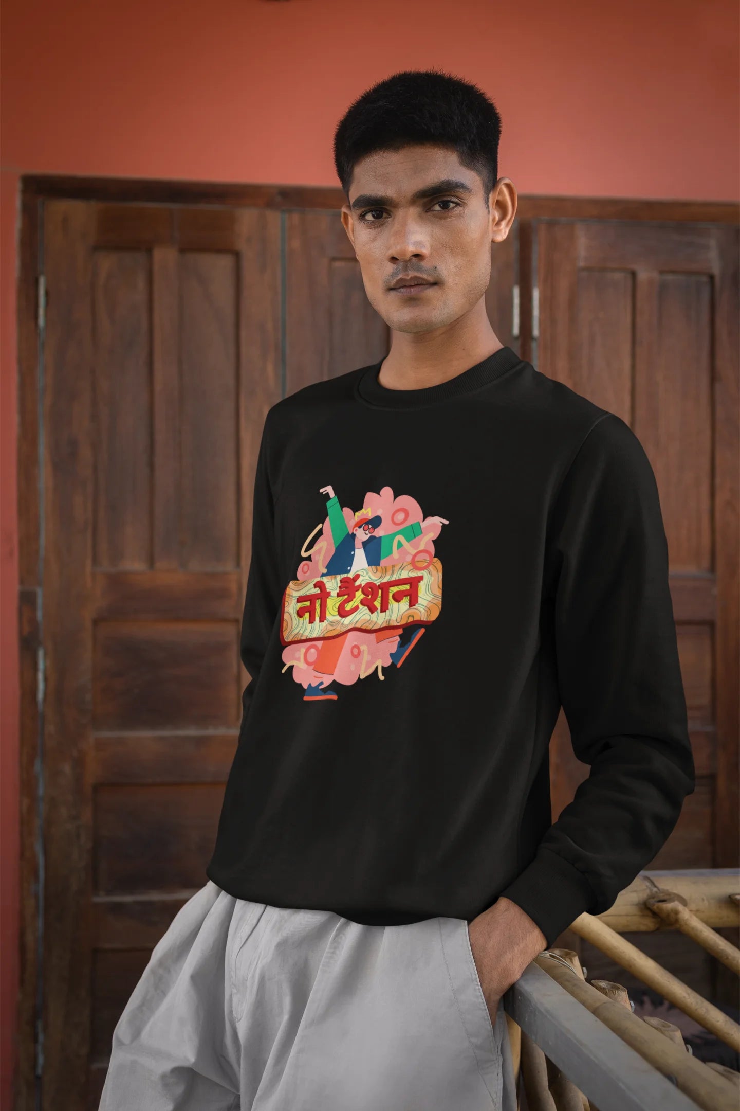 4th front view of a male model wearing a black oversized t-shirt with the phrase "No Tension" in a relaxed, unique script.