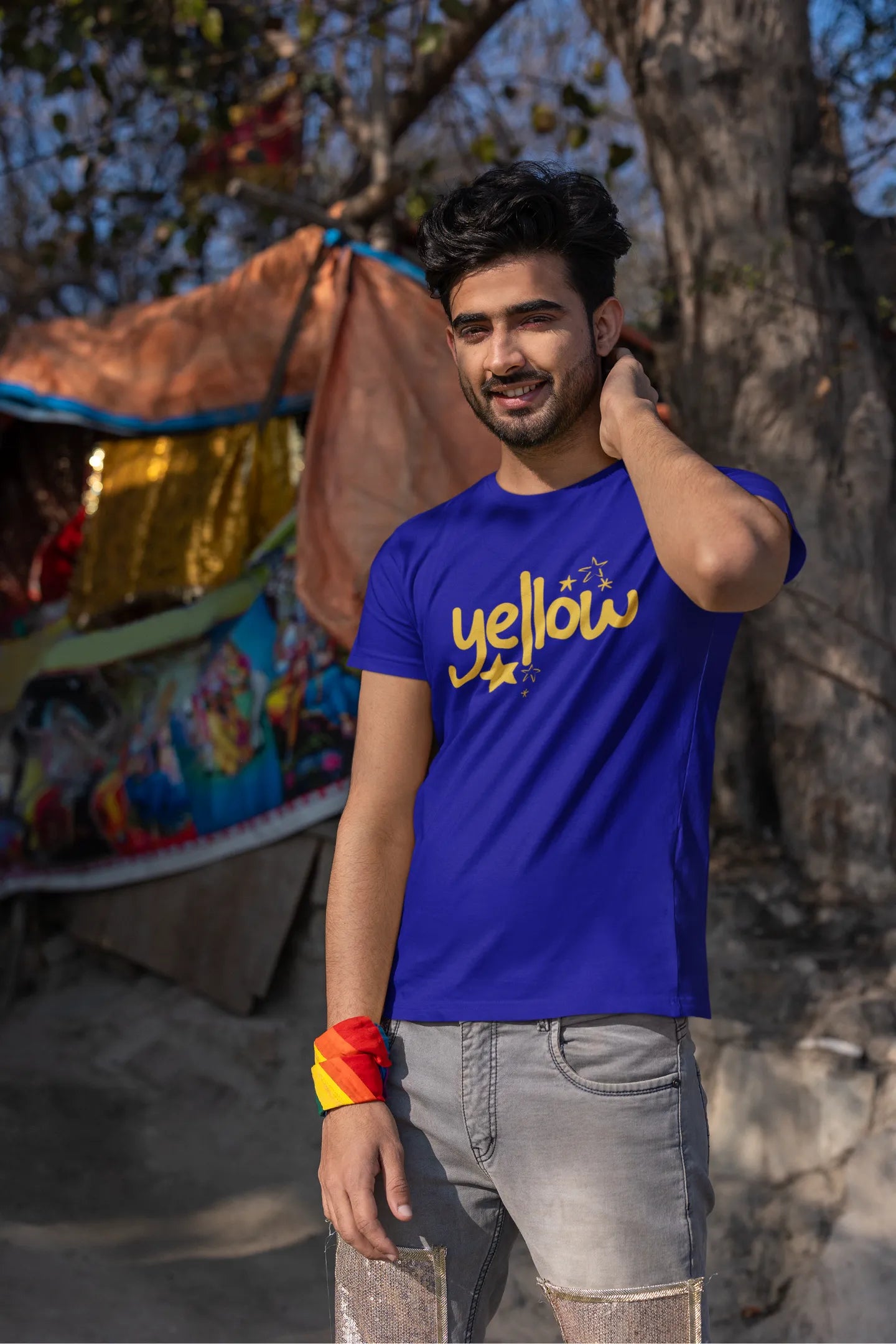 Second front view of a male model wearing a royal blue oversized t-shirt with the "Yellow" album artwork by Coldplay.