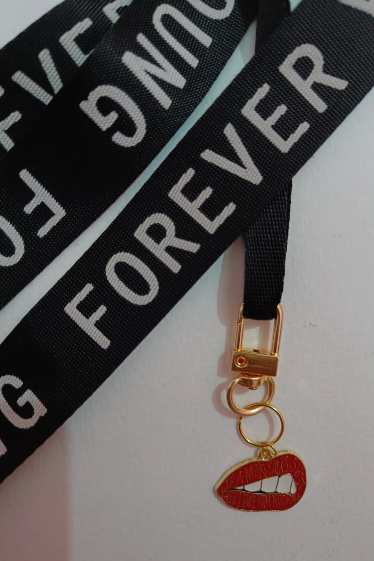 First image of an keychain featuring the Taylor Swift phrase "You Owe Him Nothing" on a lip design. Perfect for all Swifties.