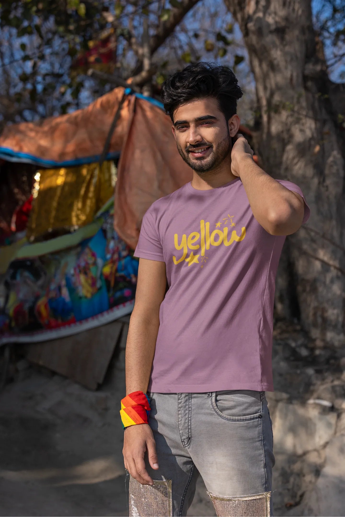 Second front view of a male model wearing a dirty purple oversized t-shirt with the "Yellow" album artwork by Coldplay.