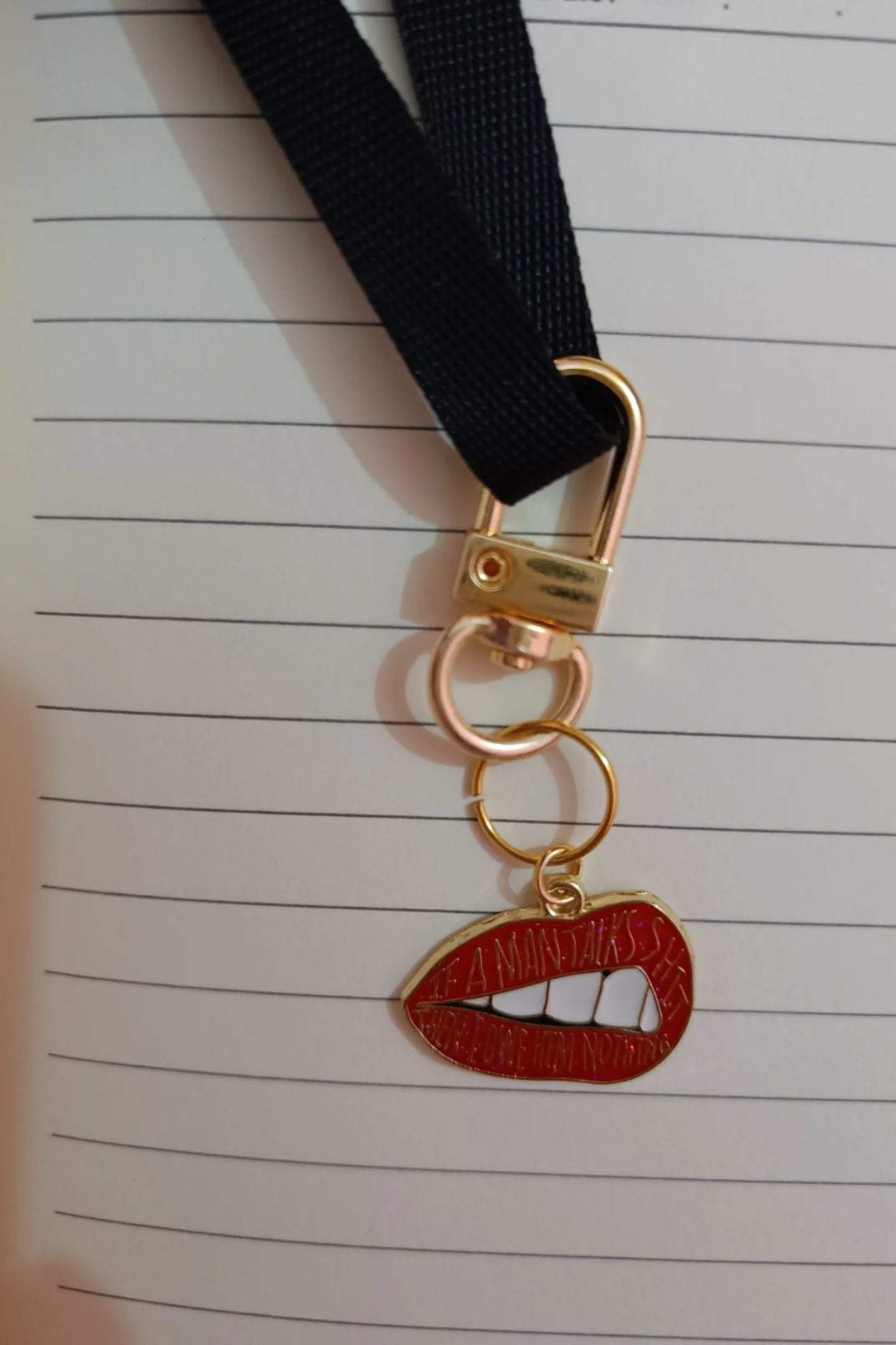 Third image of an keychain featuring the Taylor Swift phrase "You Owe Him Nothing" on a lip design. Perfect for all Swifties.