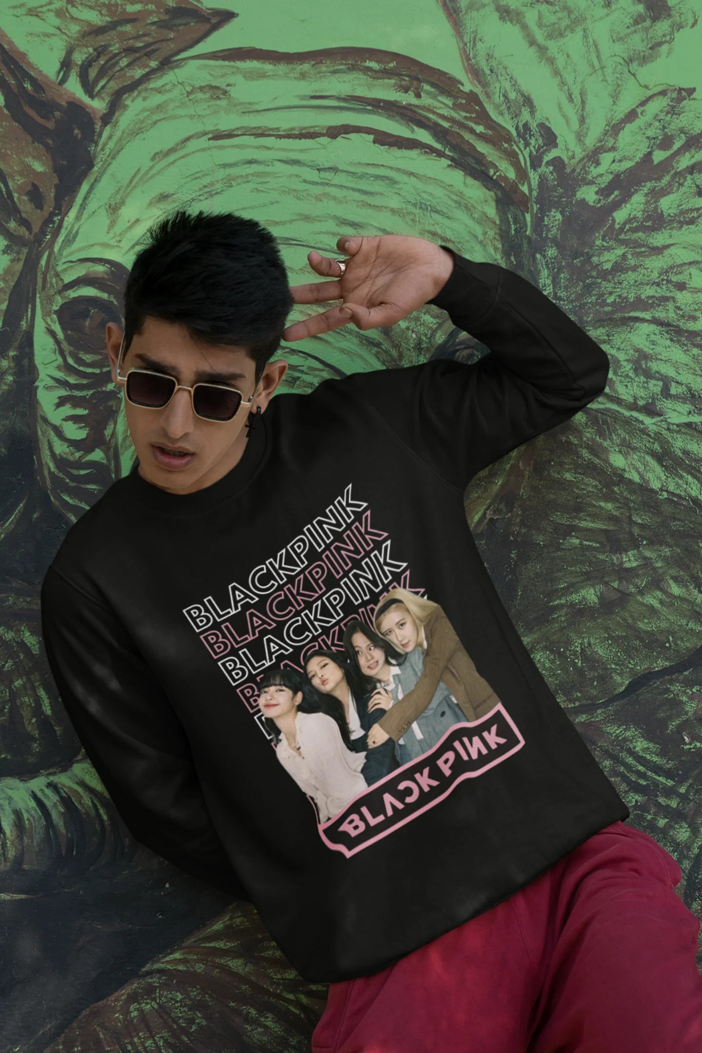 Third front view of a male model wearing a black sweatshirt featuring a stylish design inspired by the K-Pop girl group Blackpink. Ideal for Blinks (Blackpink fans) and K-Pop music enthusiasts.
