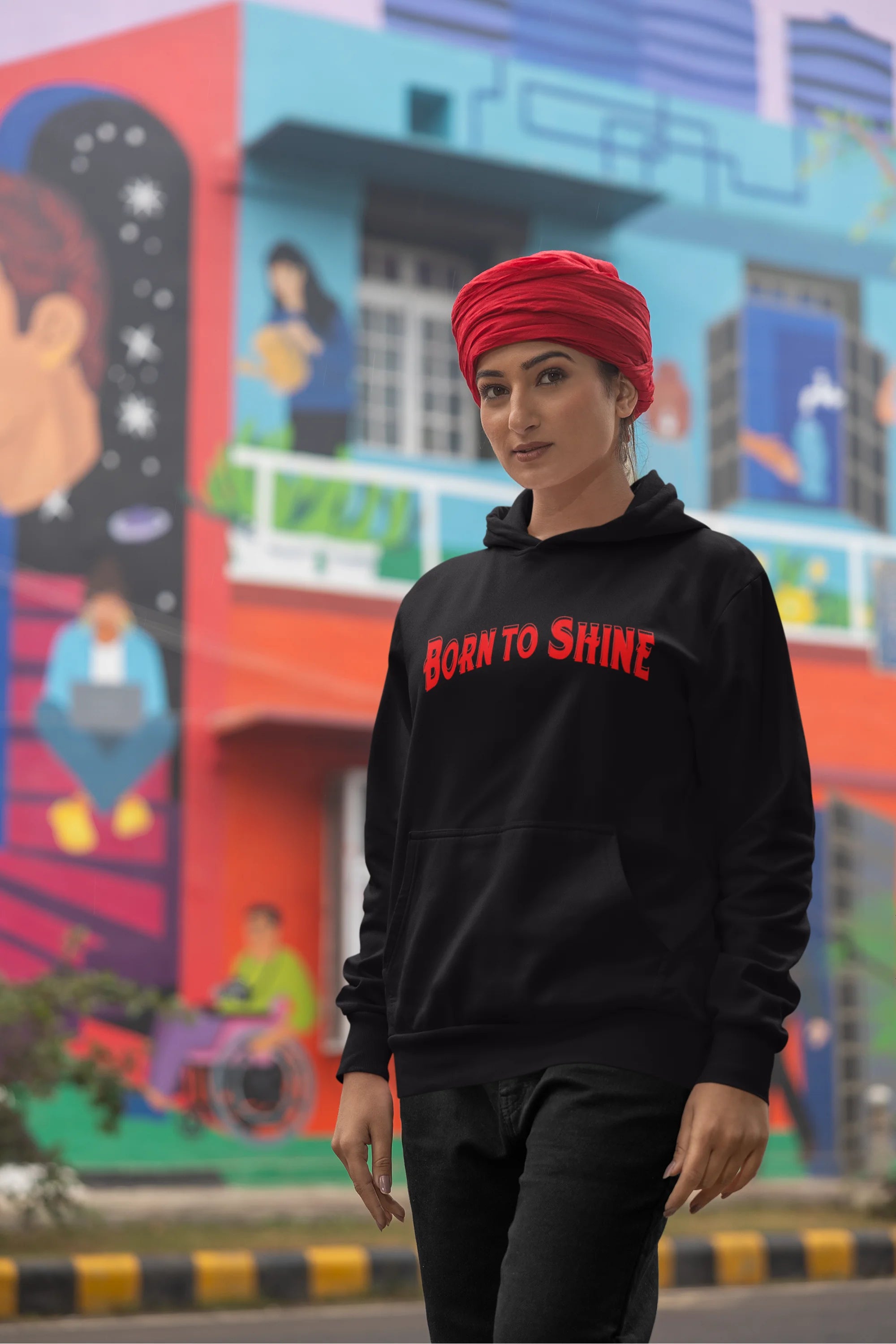 Second image of a female model wearing a black Diljit Dosanjh hoodie with the text "Born to Shine."