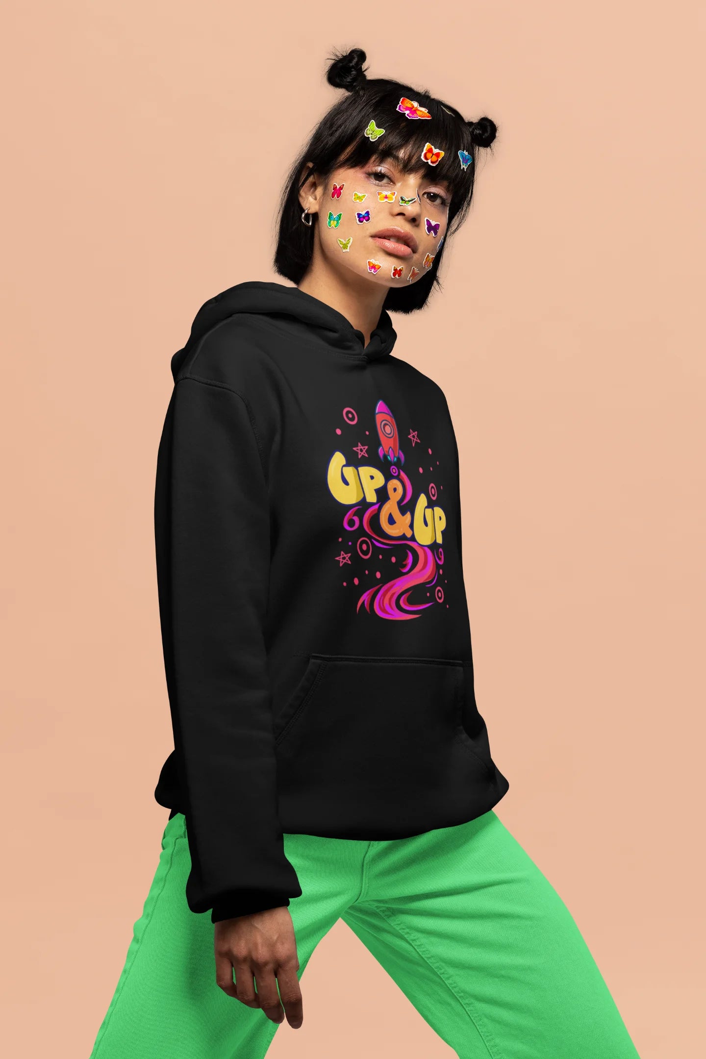 Second front view of a female model wearing an black hoodie with a rocket ship design and the text "Up & Up".
