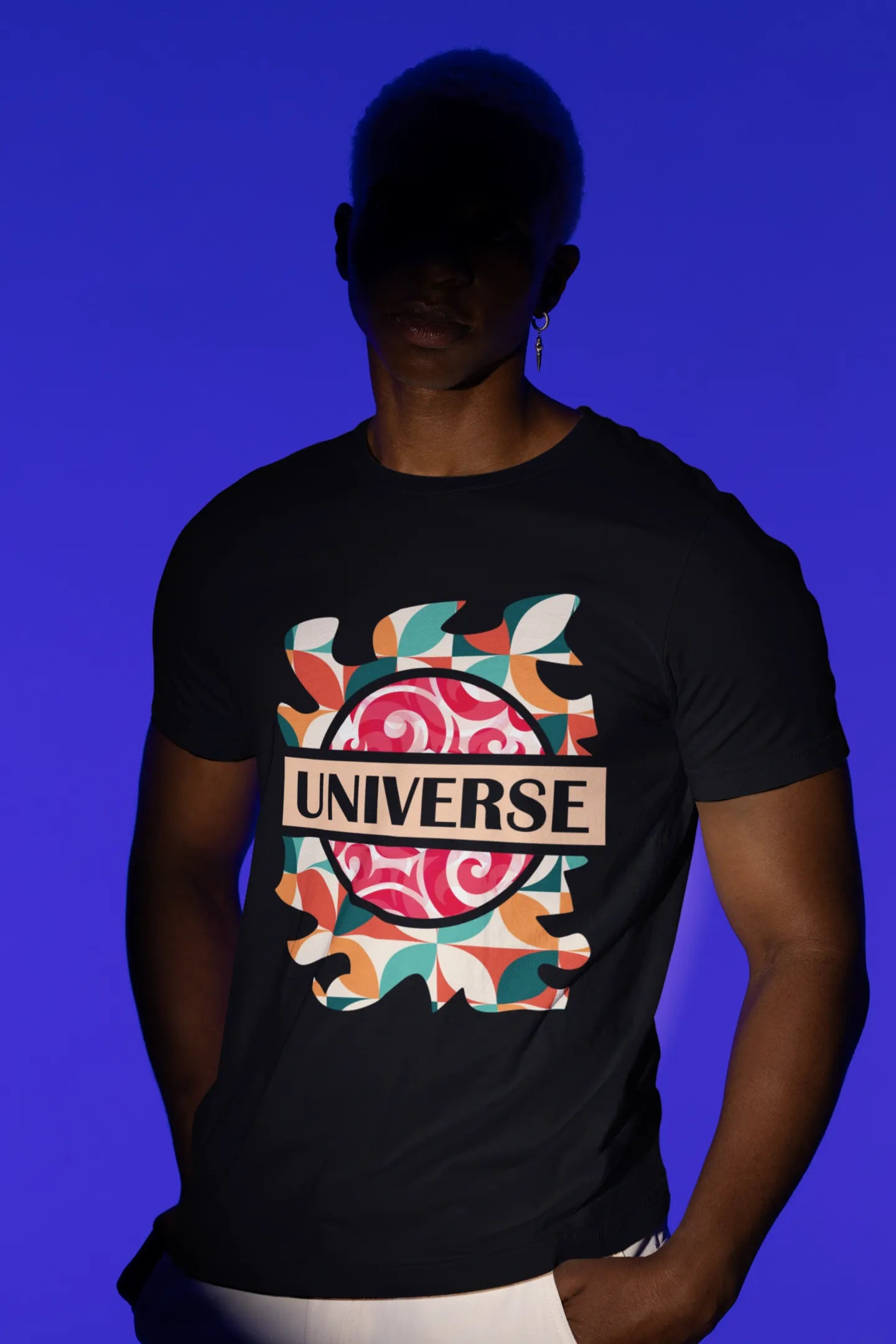 First front view of a male model wearing an black oversized t-shirt with a cosmic Universe design inspired by Coldplay.