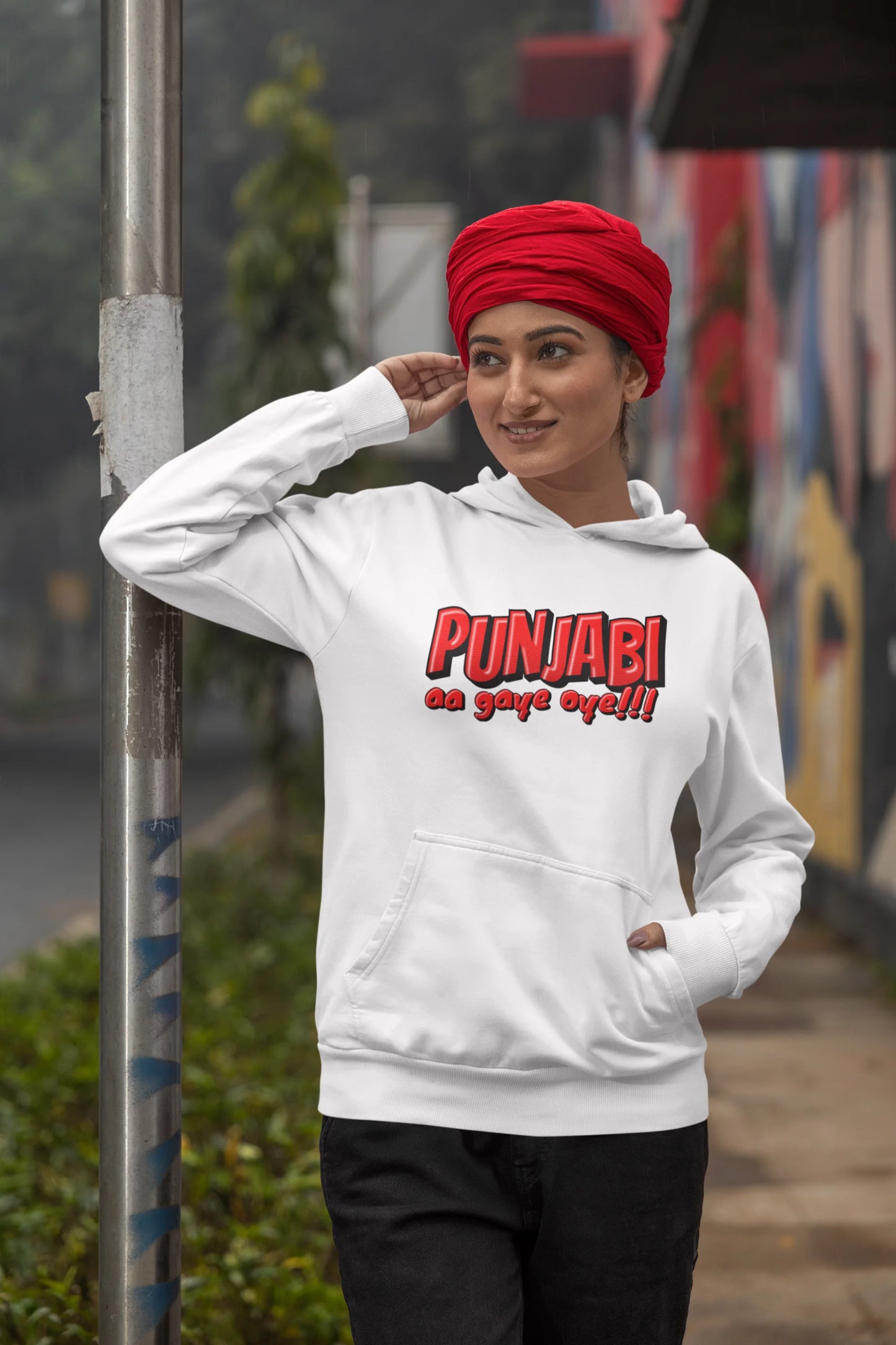First front view of a female model wearing an off-white hoodie with the text "Punjabi Aa Gaye".