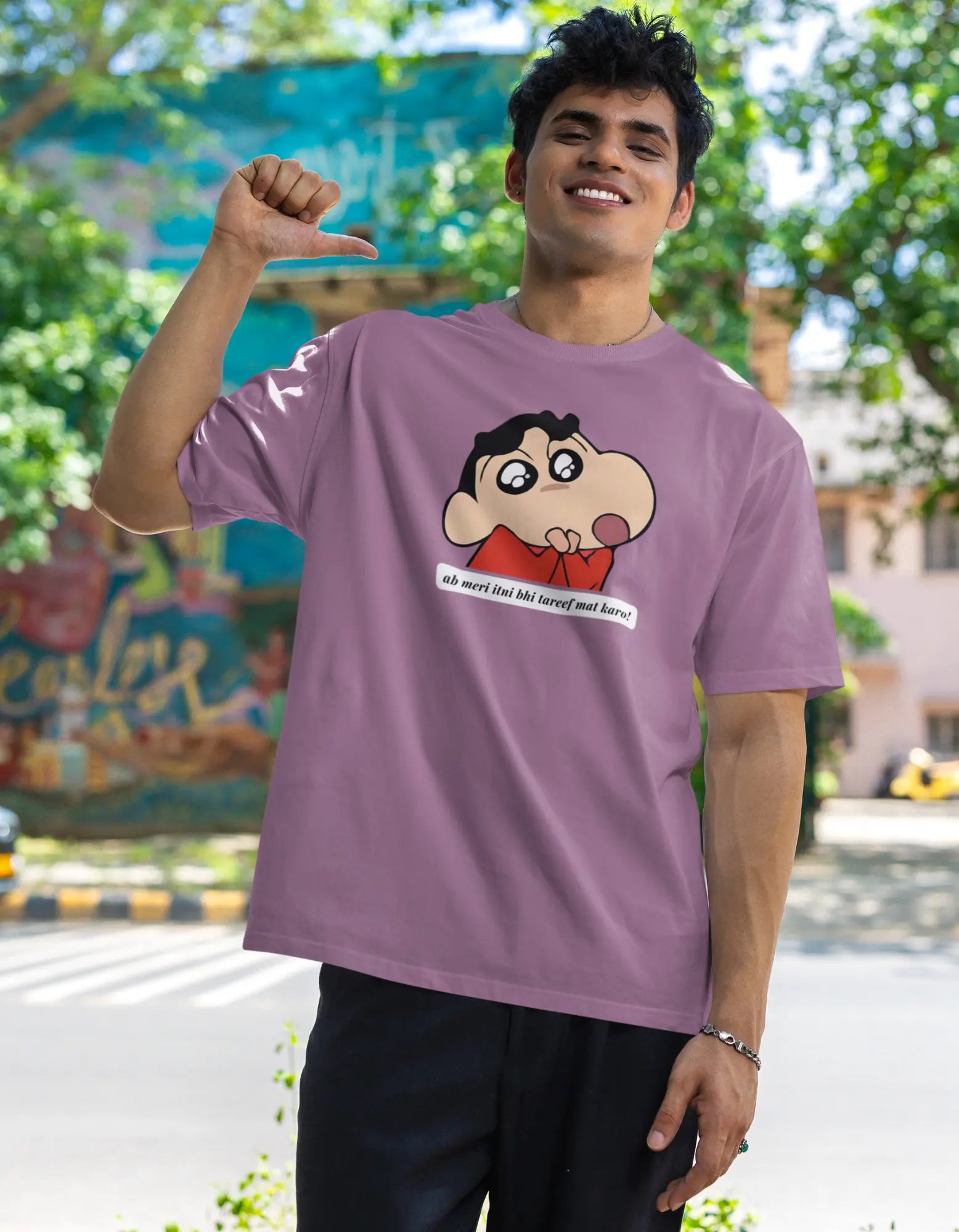 First front view of male model wearing an oversized dirty purple tee featuring Shinchan with the text "Don't Praise Me So Much" in Hindi. A perfect blend of humor and nostalgia for Shinchan fans.