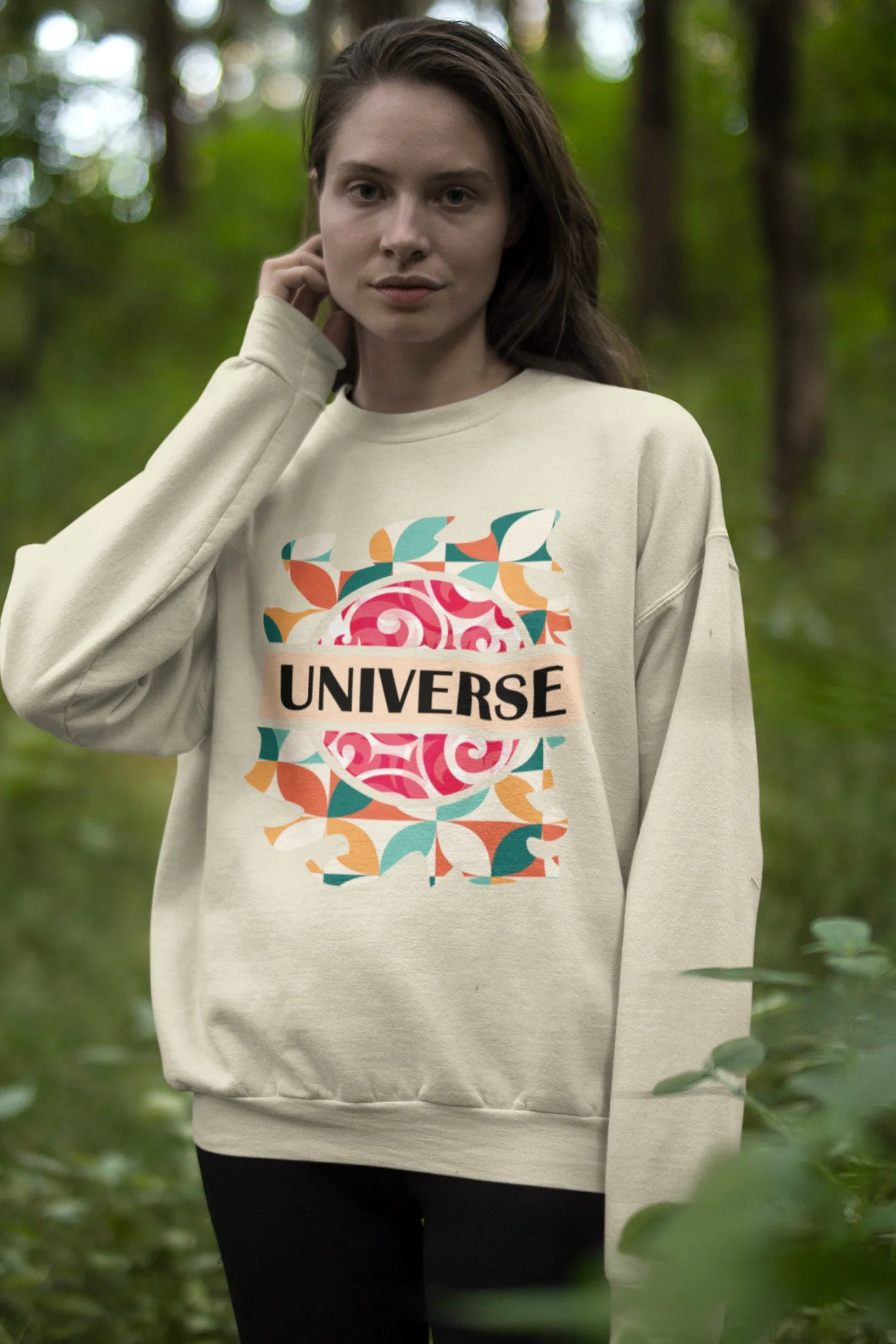 Second front view of a female model wearing an cream sweatshirt with a cosmic Universe design inspired by Coldplay.