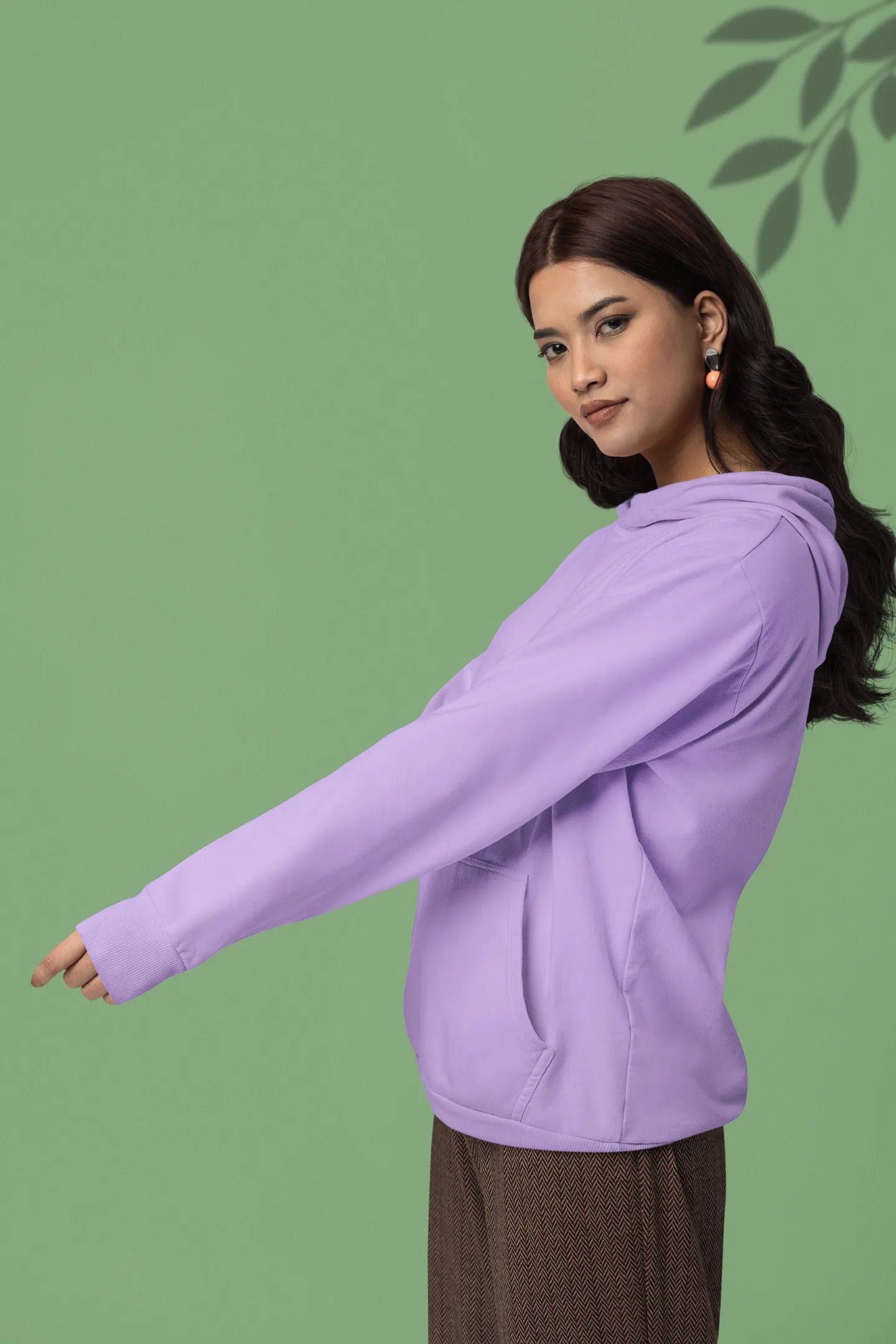 First front view of a female model wearing a lavender hoodie with a panda fox surrounded by bamboo.