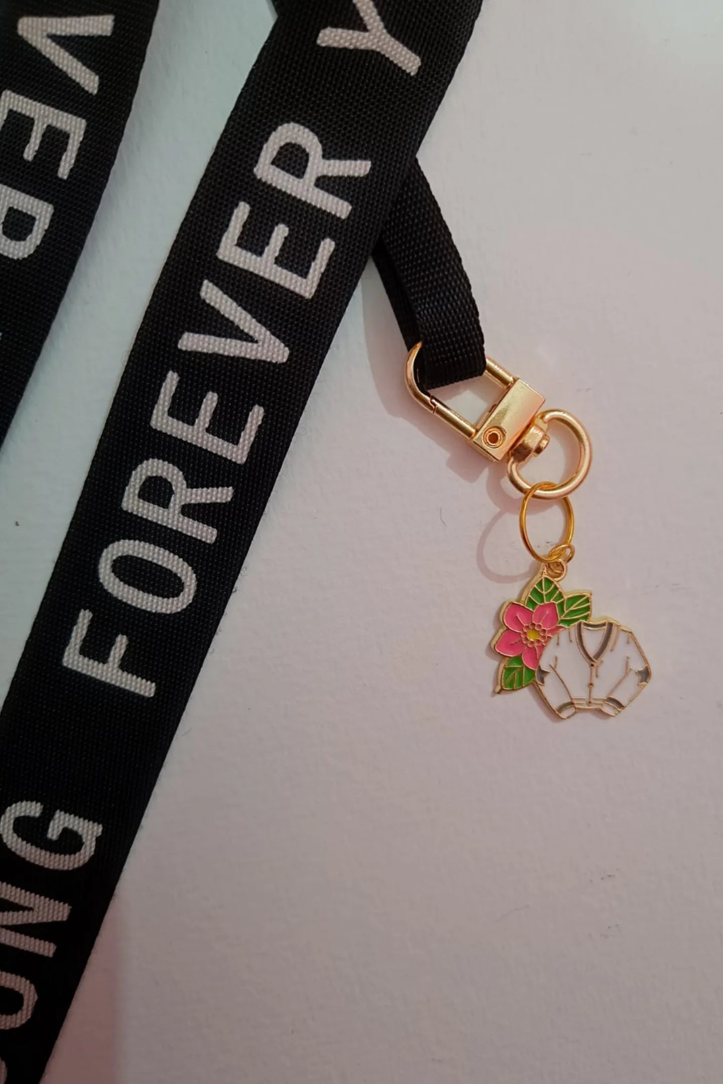 First view of a cute swiftie keychain featuring a Cardigan design inspired by Taylor Swift's "Folklore" album.