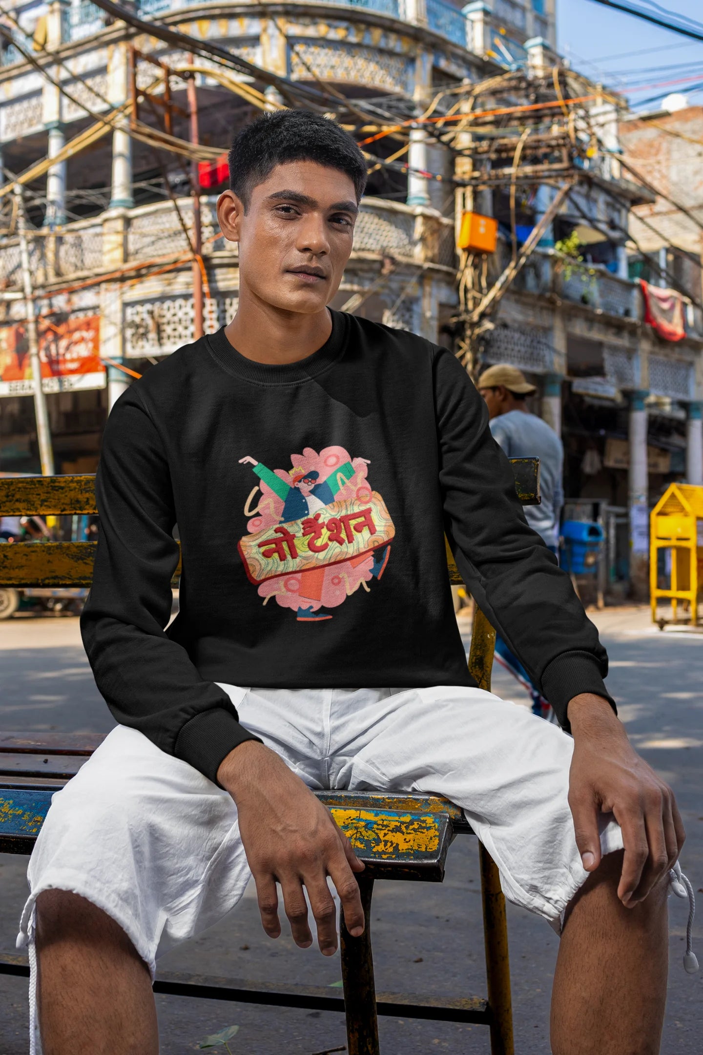 5th front view of a male model wearing a black oversized t-shirt with the phrase "No Tension" in a relaxed, unique script.