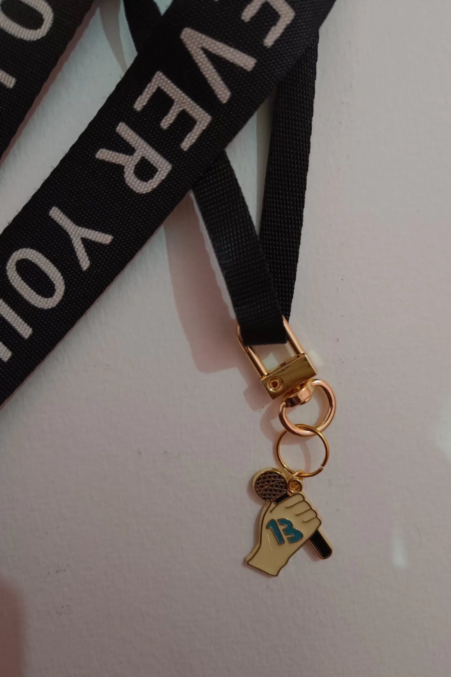 Third view of a keychain featuring the number thirteen, symbolizing Taylor Swift's lucky number.